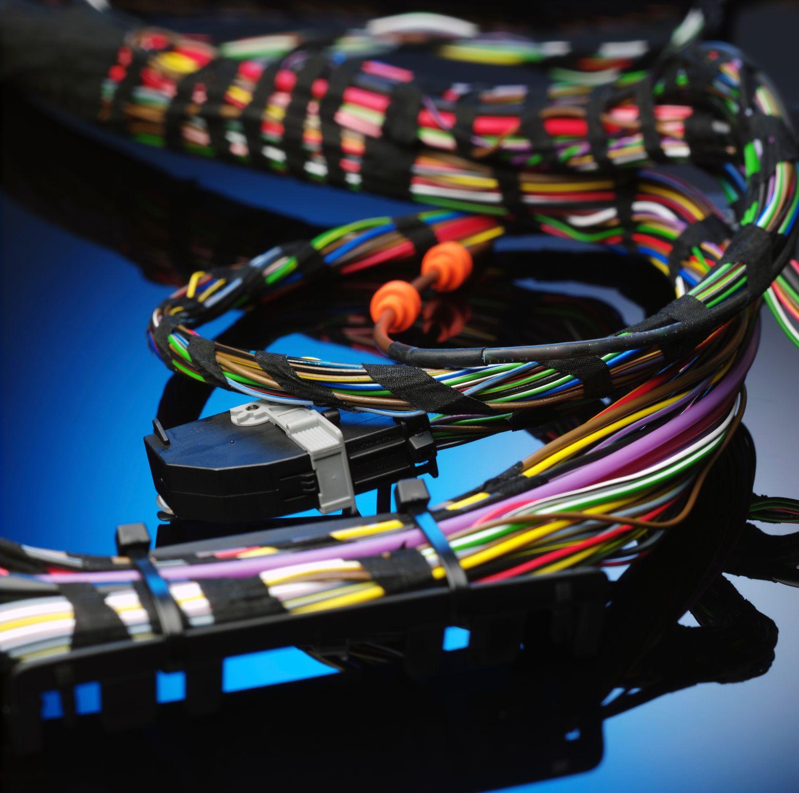 Technician inspecting a completed wire harness